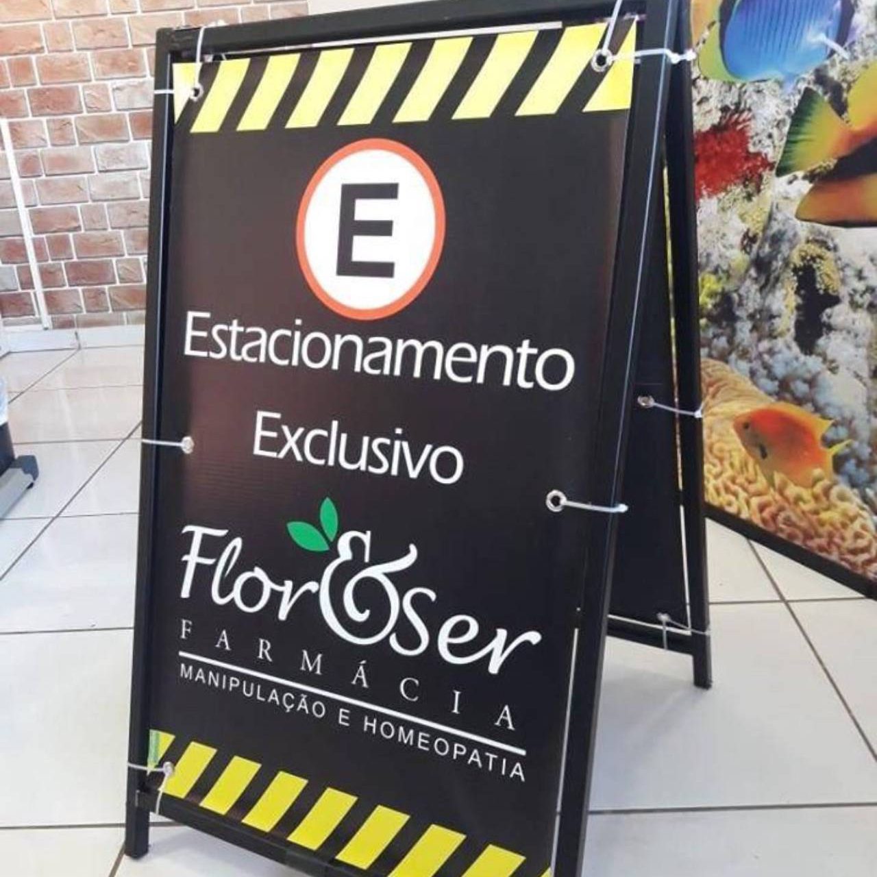 cavalete de calçada preta com símbolo de estacionamento exclusivo e texto.
